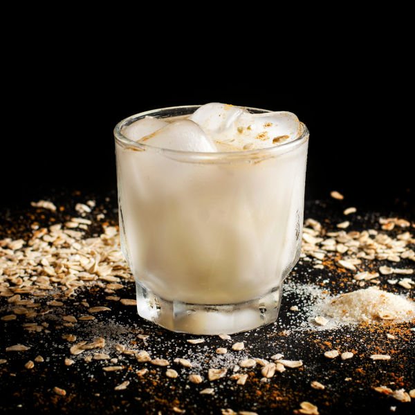 Horchata valenciana cremosa servie en vaso avec fartons dulces recién horneados